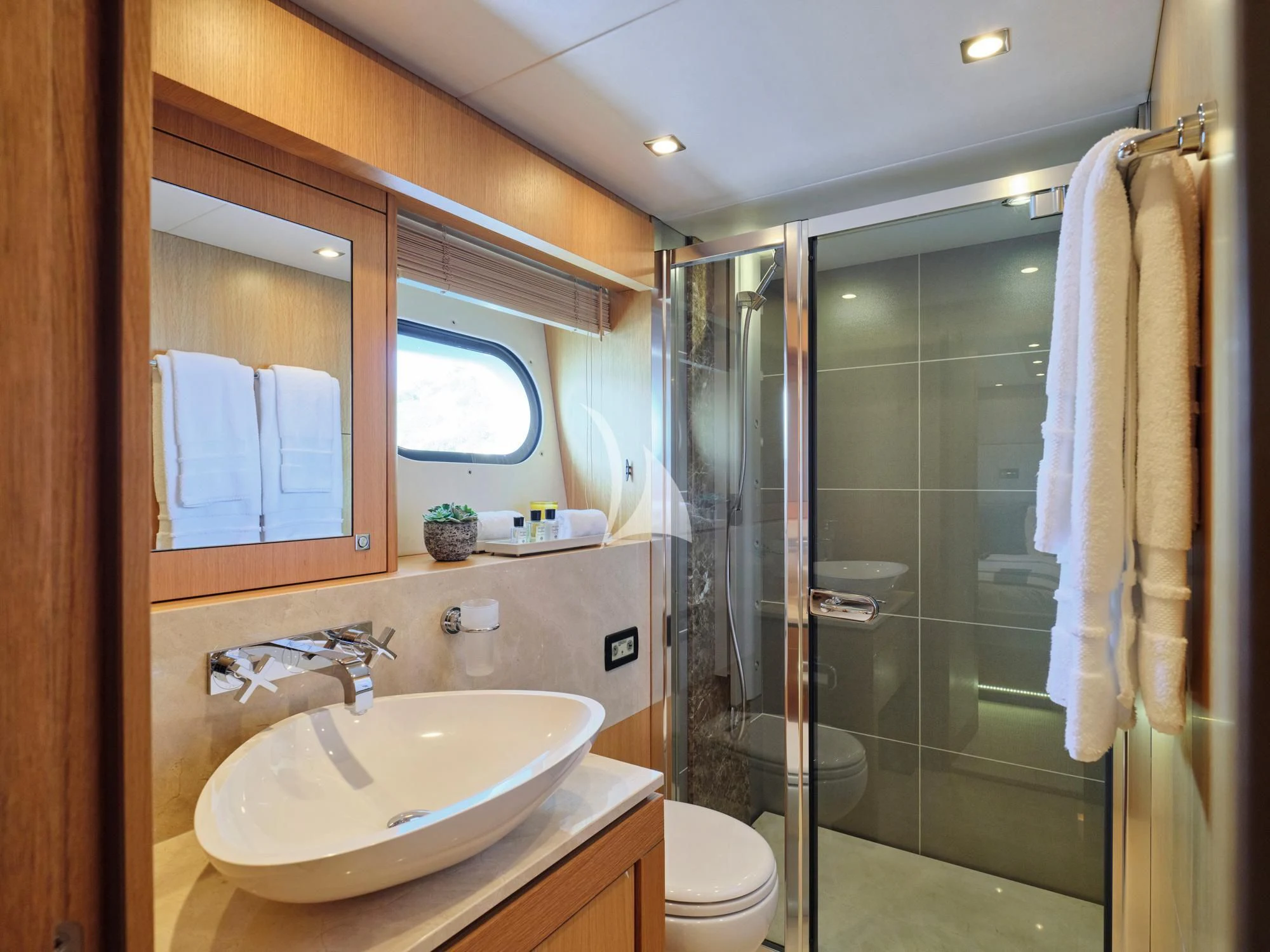 a bathroom with a glass shower door aboard MAKANI II Yacht for Charter