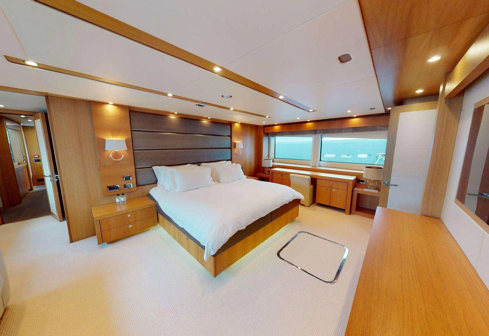 a large hotel room with a large bed and a large window aboard MAKANI II Yacht for Charter