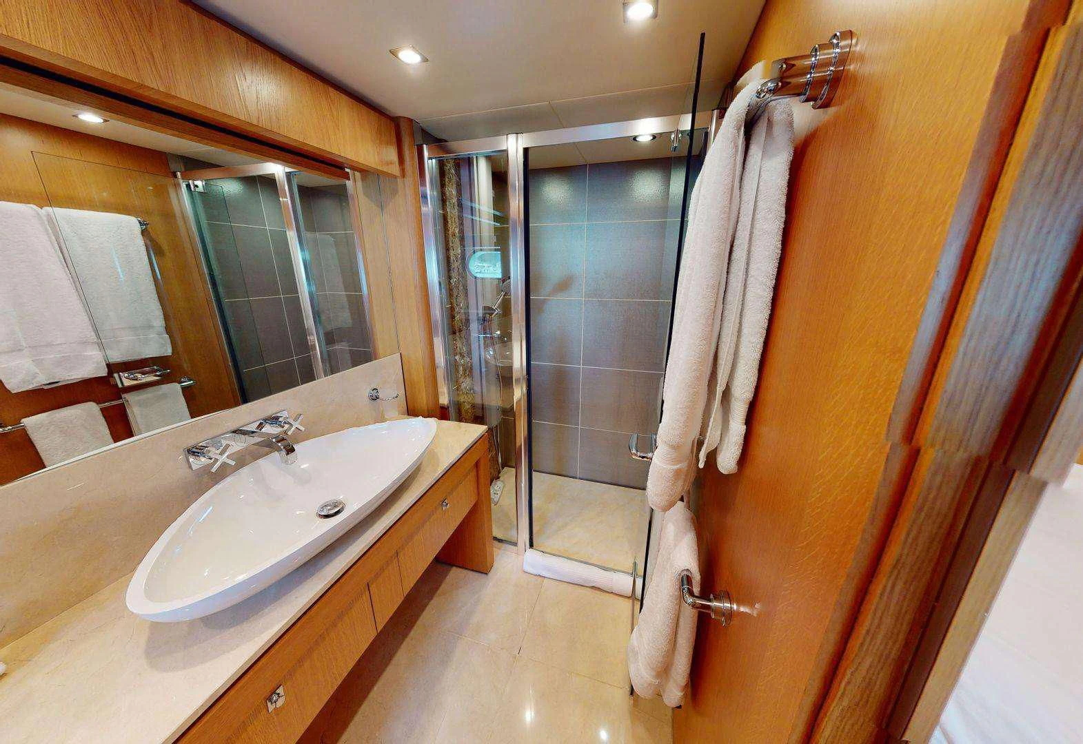 a bathroom with a sink and a shower aboard MAKANI II Yacht for Charter