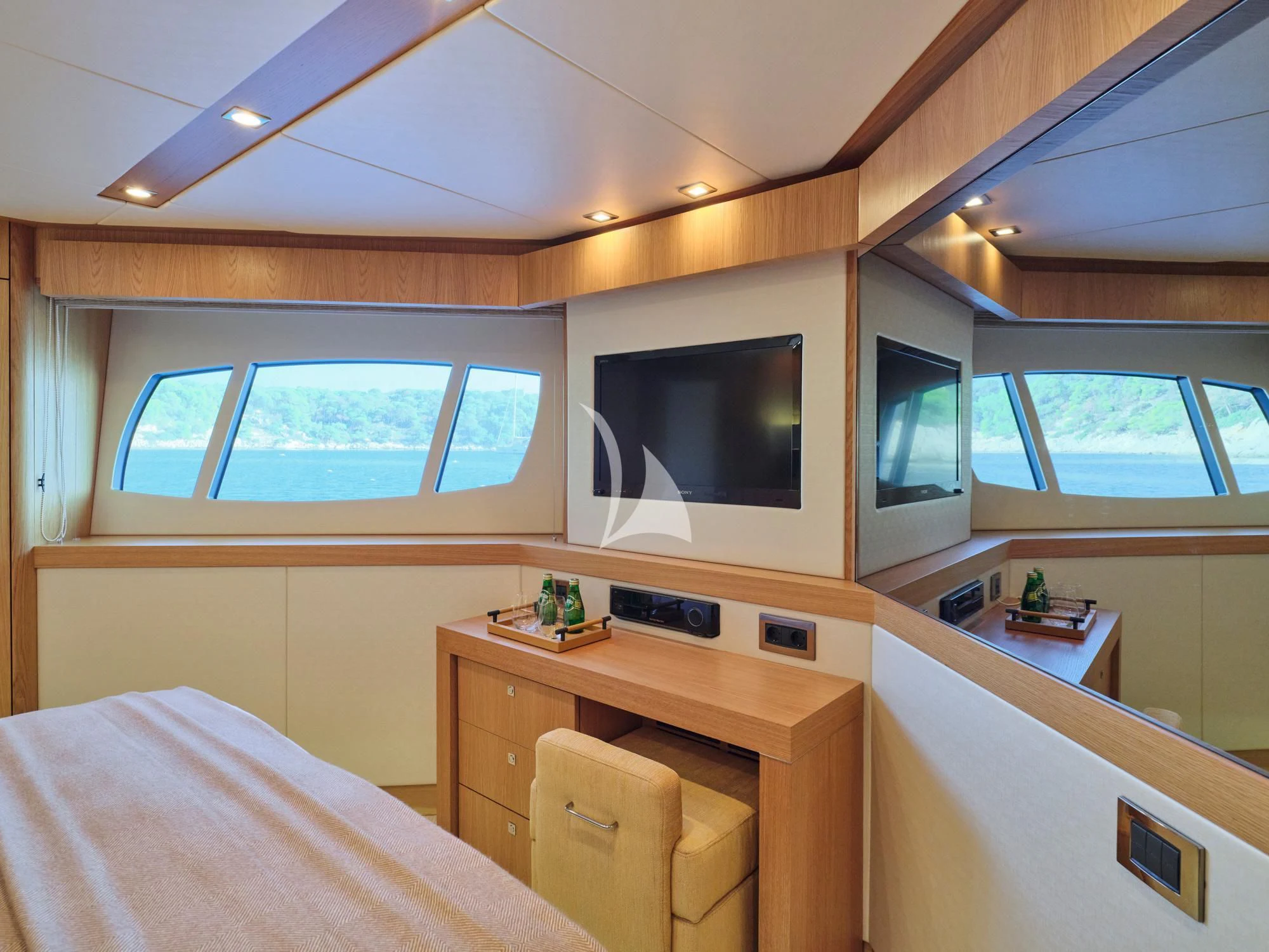 a bedroom with a bed and a tv aboard MAKANI II Yacht for Charter