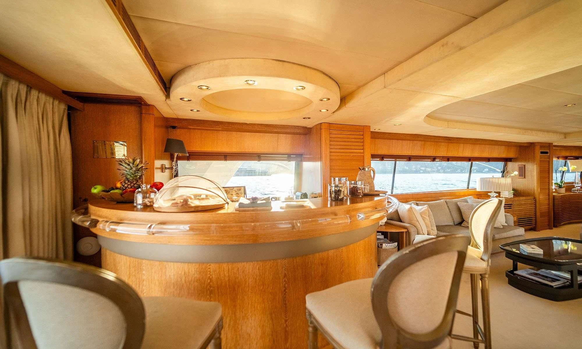 a kitchen with a bar and chairs aboard SEA LADY II Yacht for Sale