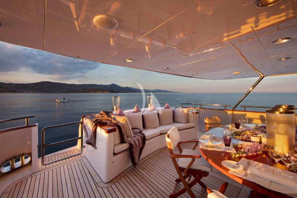 a room with a table and chairs aboard SEA LADY II Yacht for Sale