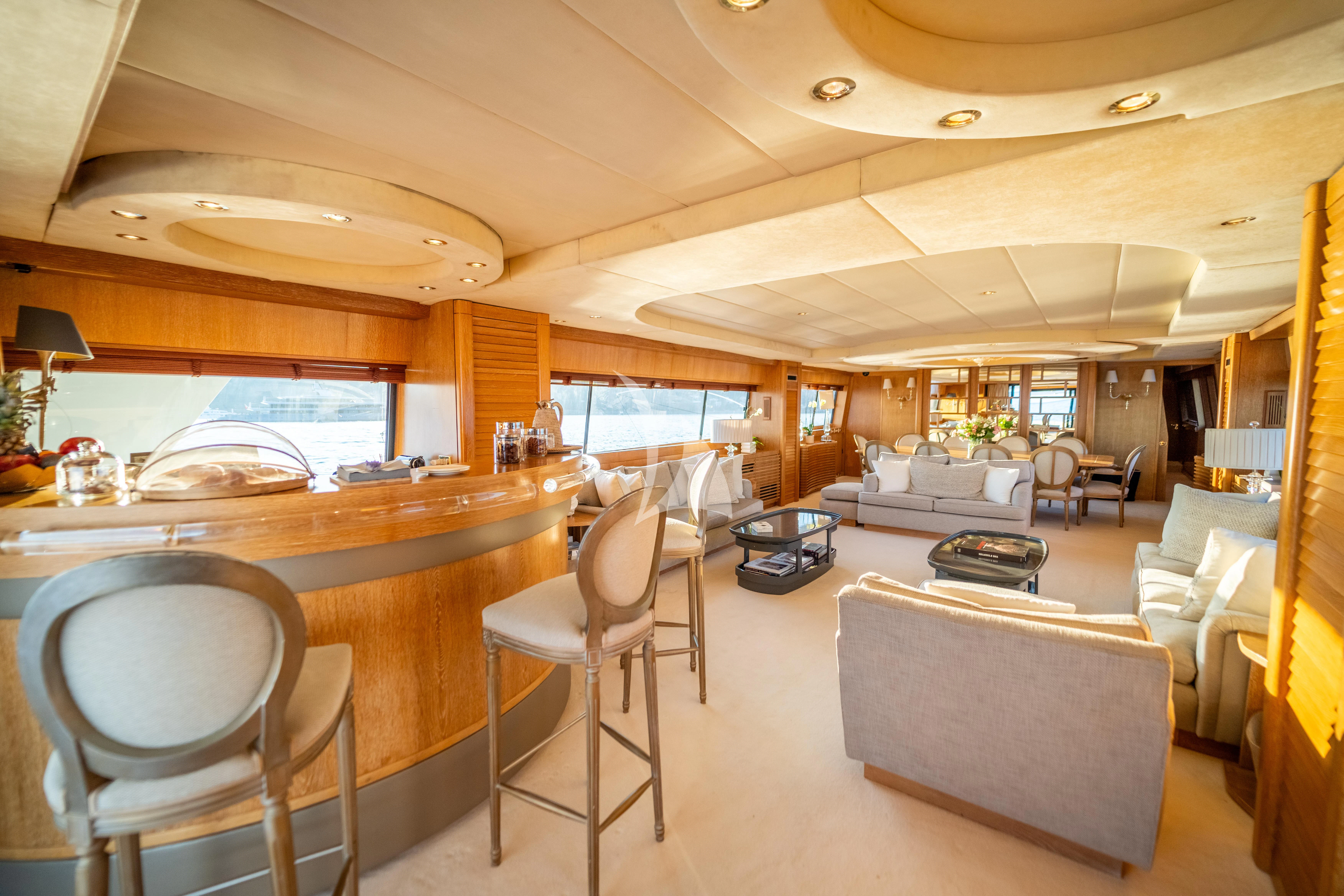 a living room with a table and chairs aboard SEA LADY II Yacht for Sale