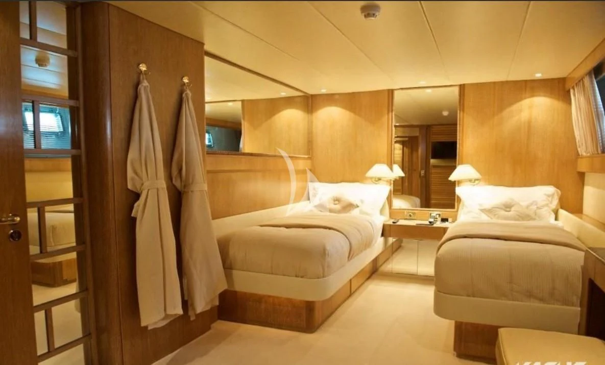 a room with a bed and a mirror aboard SEA LADY II Yacht for Sale