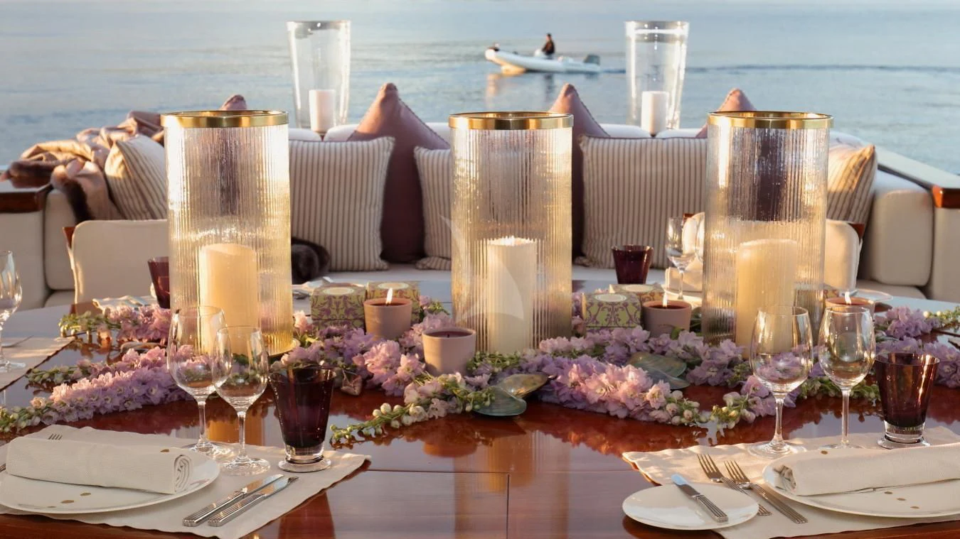 a table with plates and glasses on it aboard SEA LADY II Yacht for Sale