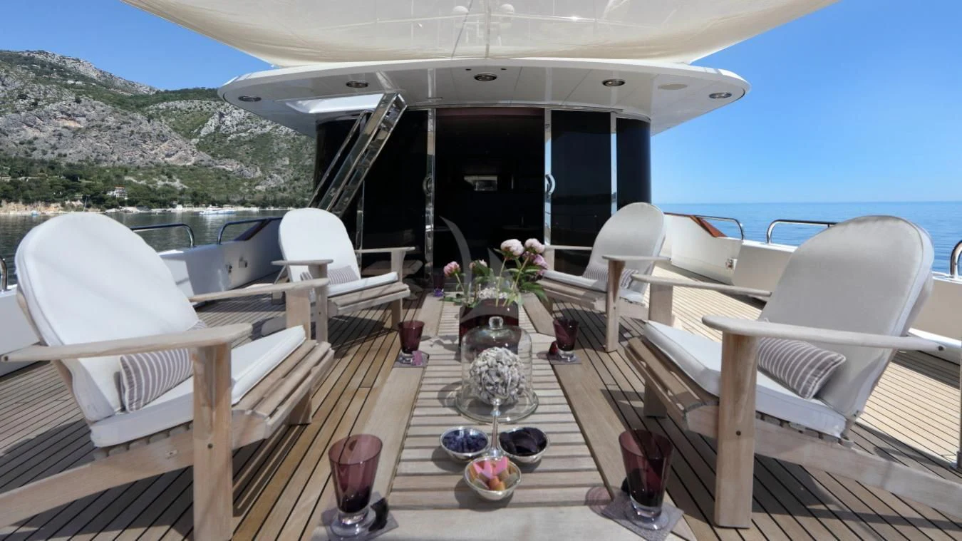 a deck with chairs and tables on it aboard SEA LADY II Yacht for Sale