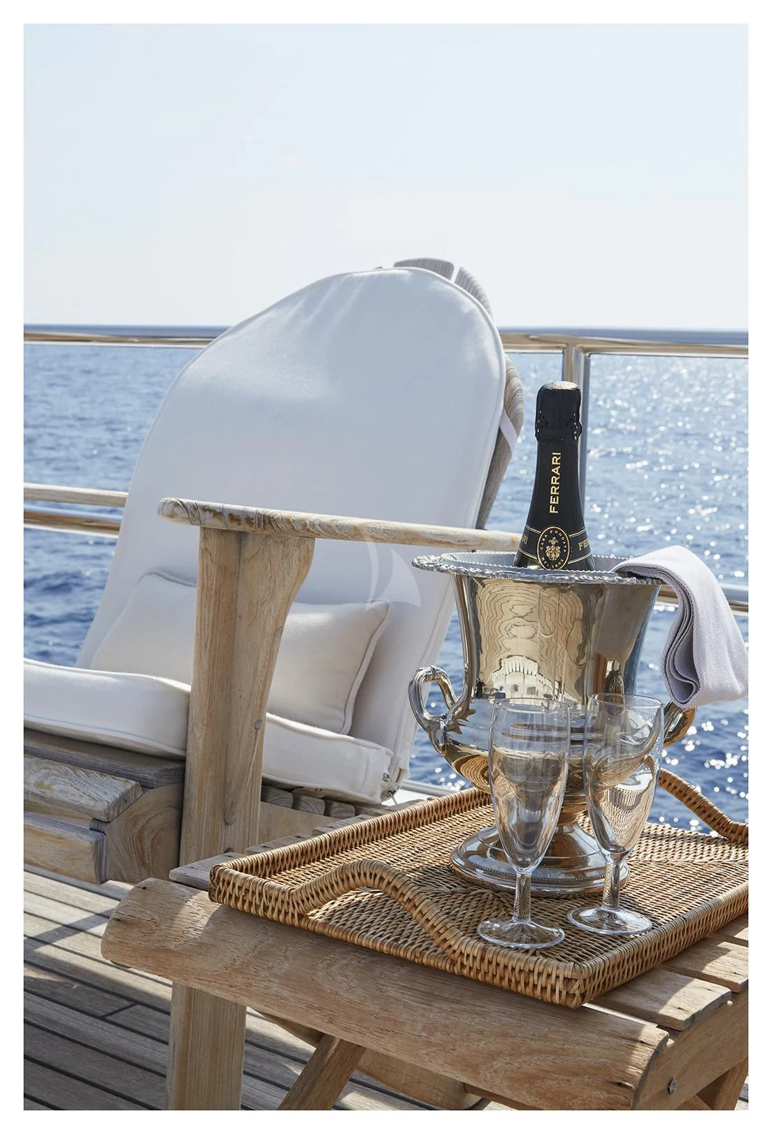 a wine glass and a bottle on a table aboard SEA LADY II Yacht for Sale