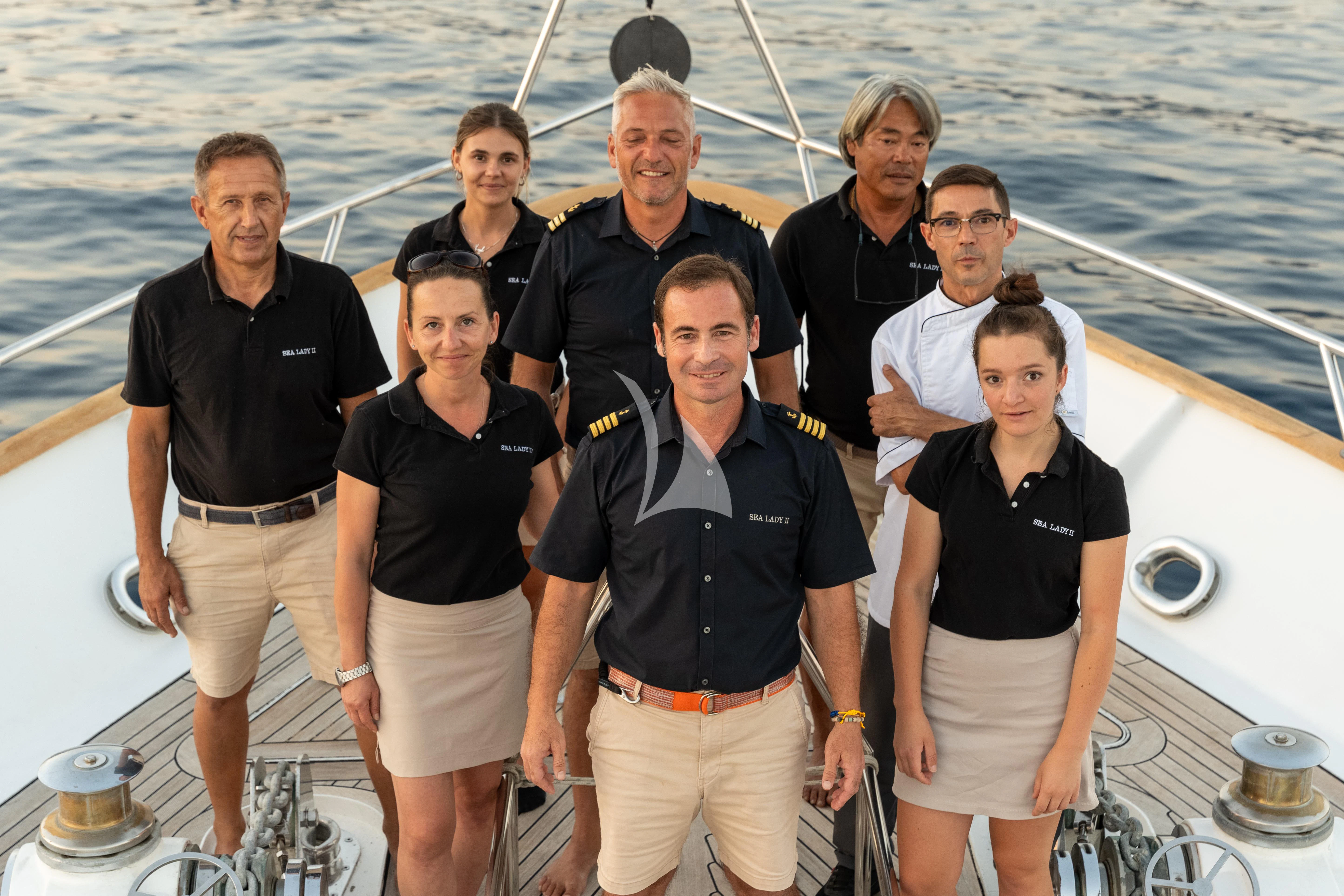 a group of people posing for a photo on a boat aboard SEA LADY II Yacht for Sale