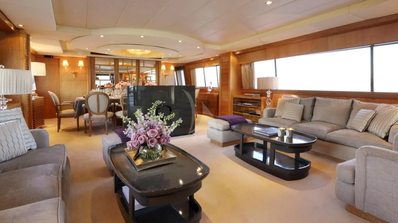 a living room with a large fireplace aboard SEA LADY II Yacht for Sale