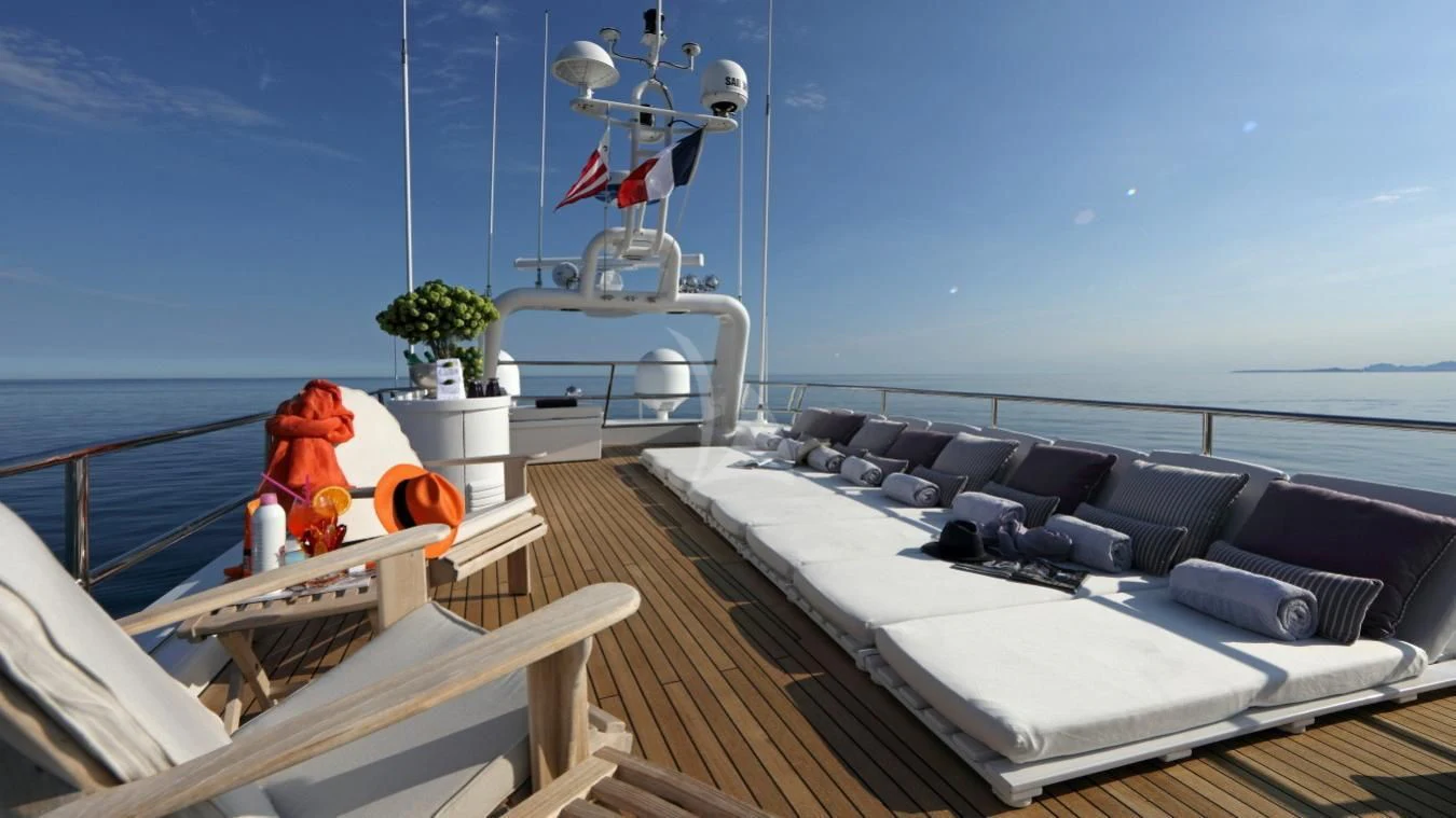 a boat with a bed and a large orange toy on the deck aboard SEA LADY II Yacht for Sale
