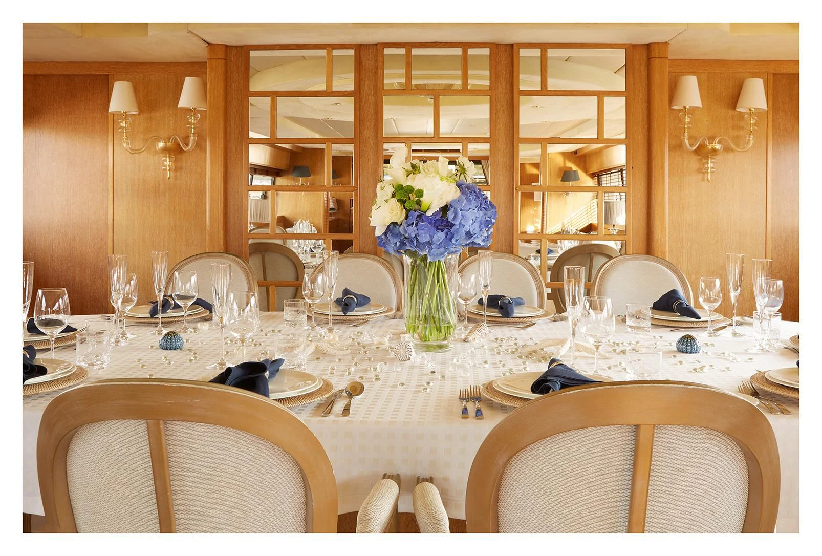 a table set with chairs and flowers aboard SEA LADY II Yacht for Sale