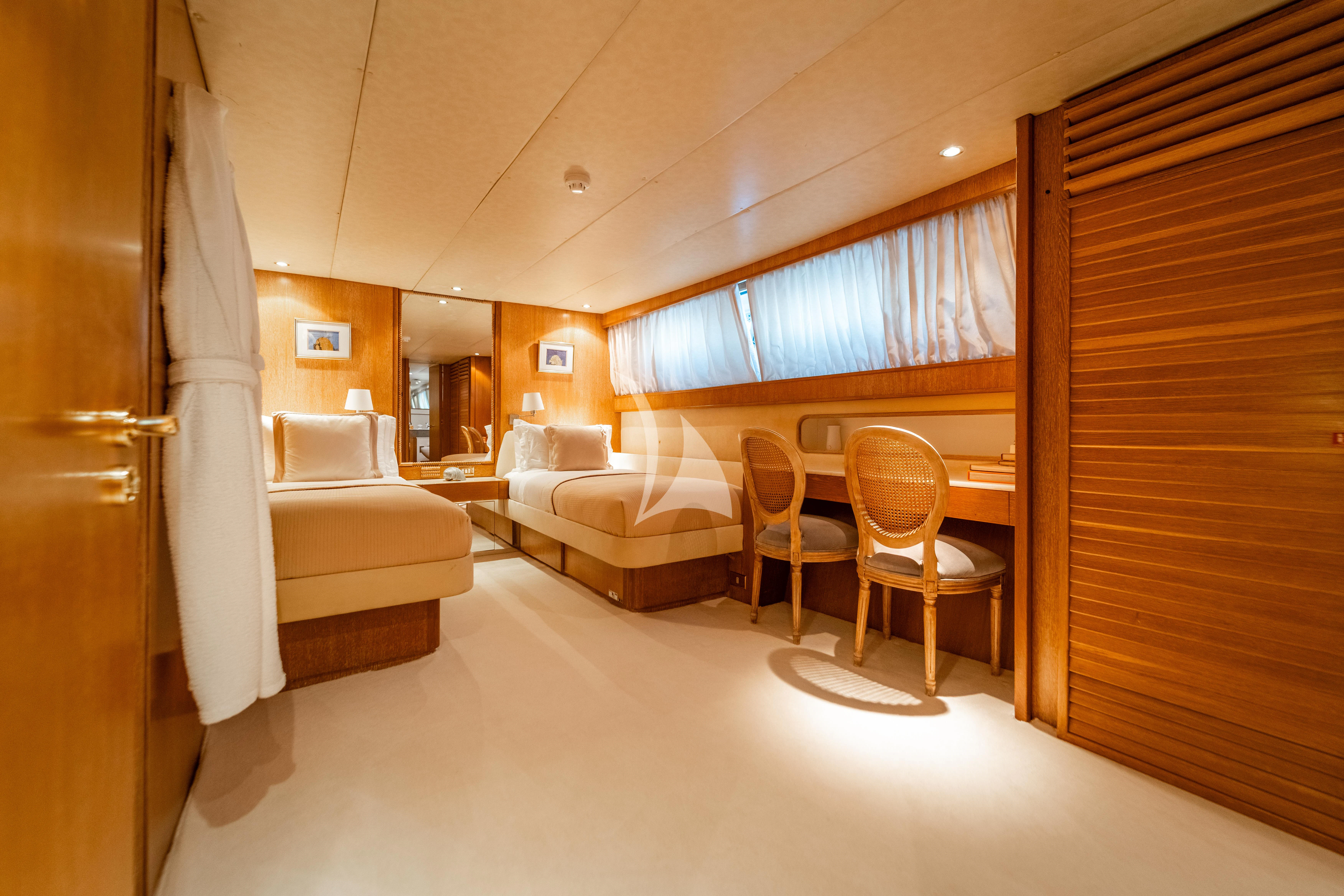 a room with a bed and a couch aboard SEA LADY II Yacht for Sale