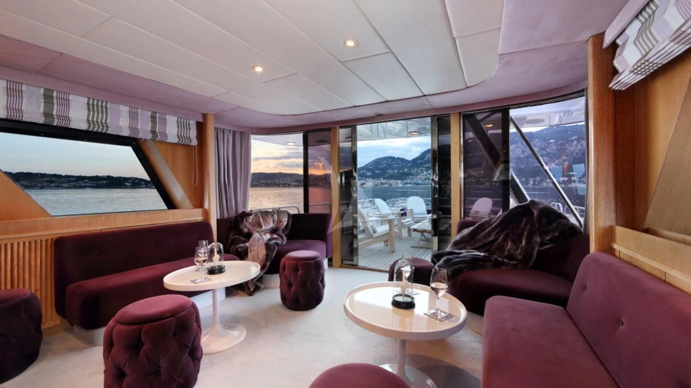 a living room with a large window aboard SEA LADY II Yacht for Sale
