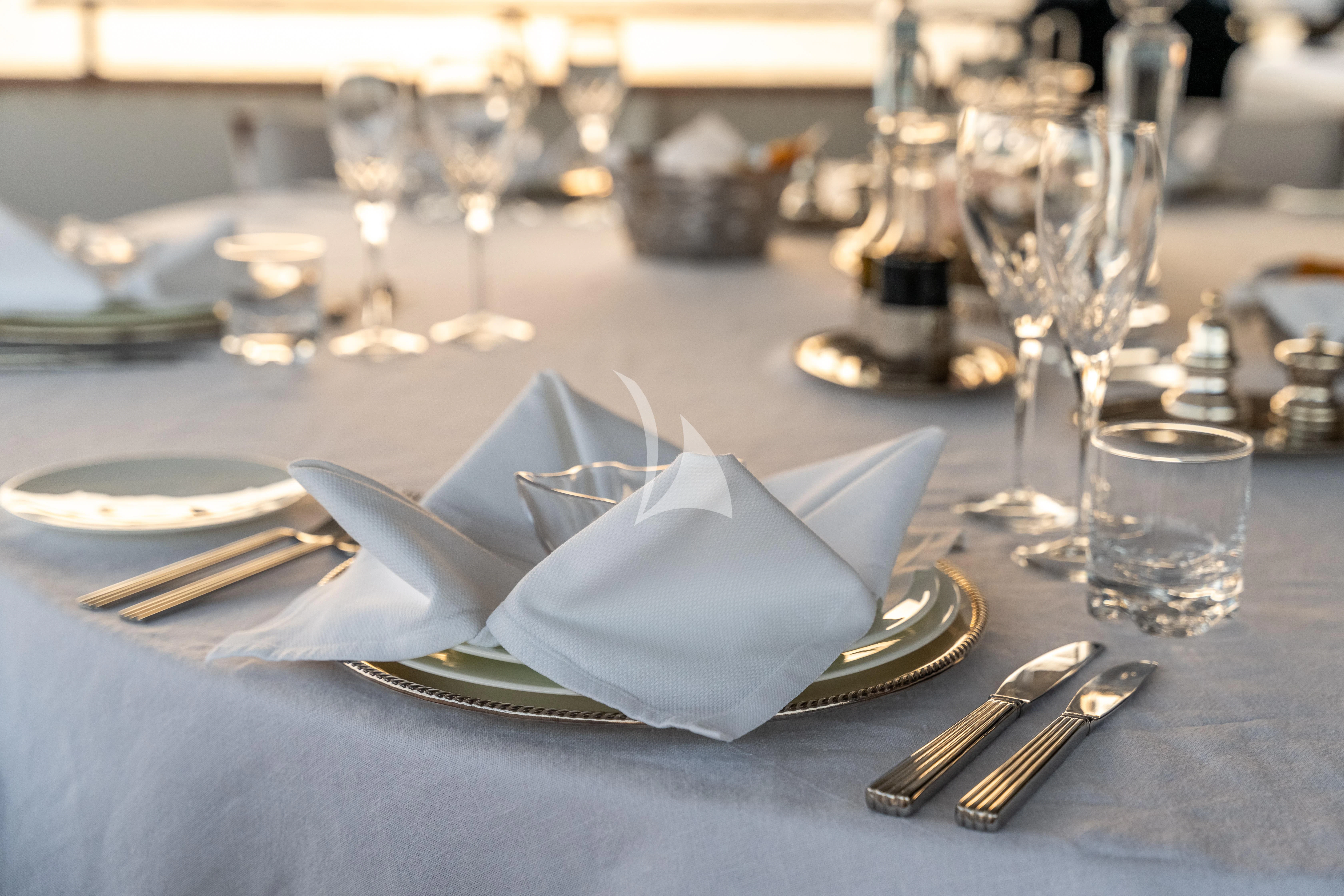 a table with place settings aboard SEA LADY II Yacht for Sale