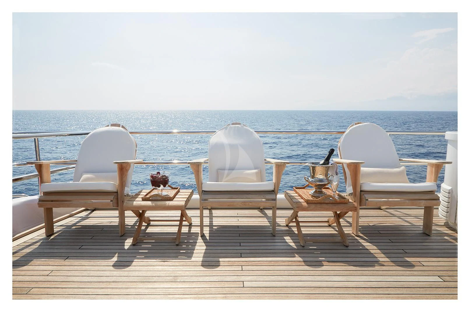 a group of chairs on a deck overlooking the ocean aboard SEA LADY II Yacht for Sale