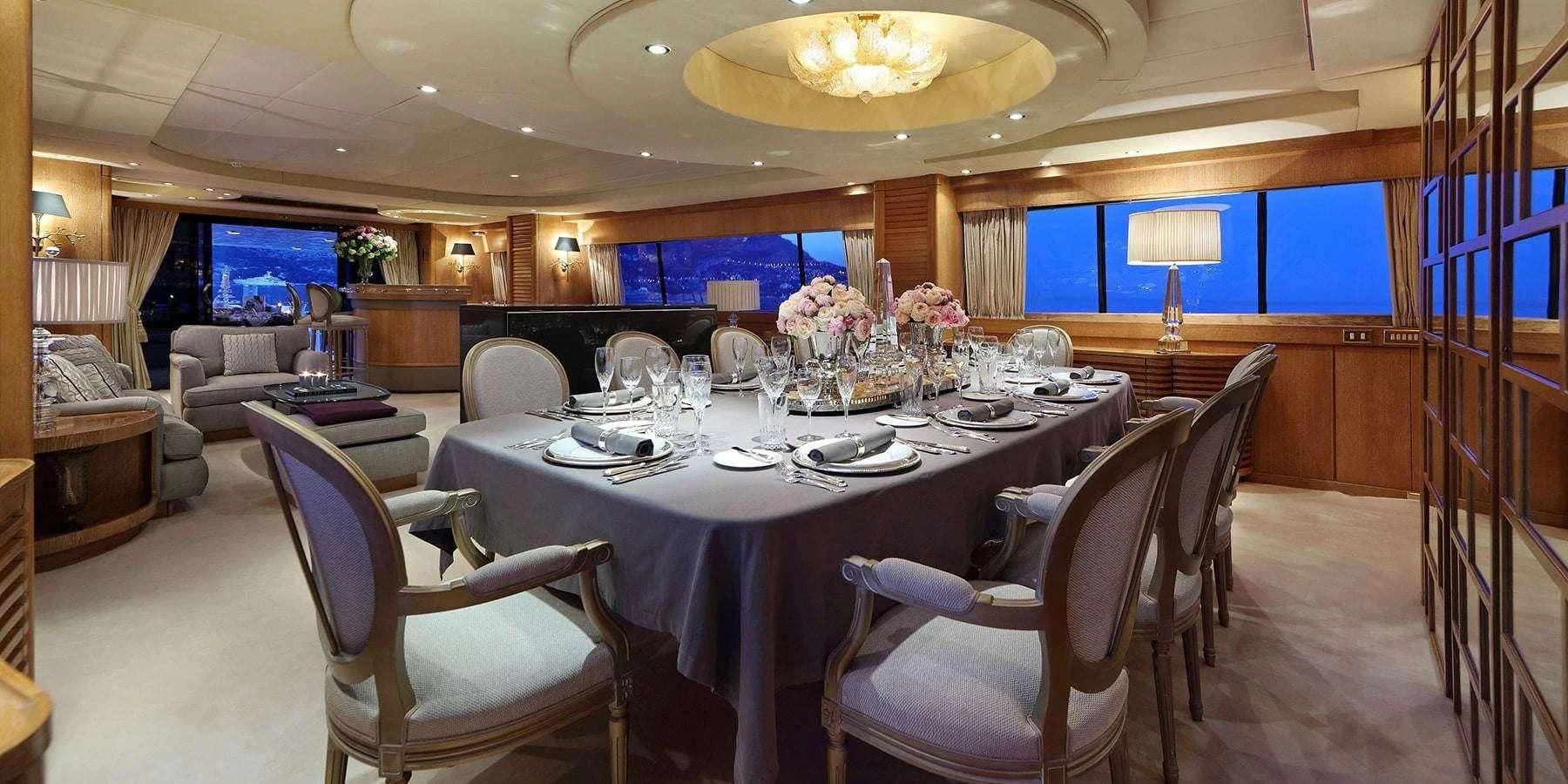 a dining room with a table and chairs aboard SEA LADY II Yacht for Sale