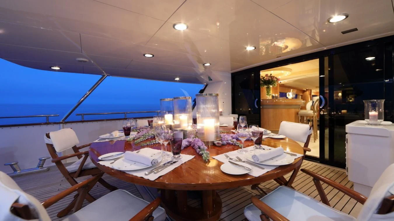 a table with plates and glasses on it aboard SEA LADY II Yacht for Sale