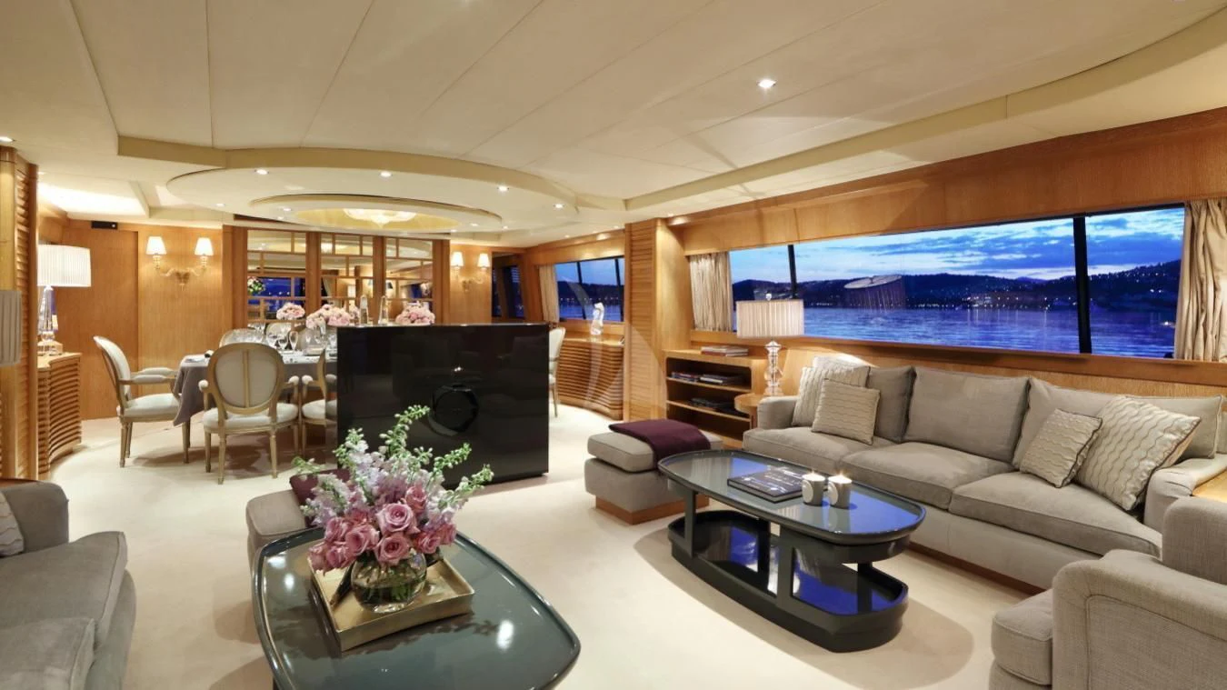 a living room with a fireplace aboard SEA LADY II Yacht for Sale