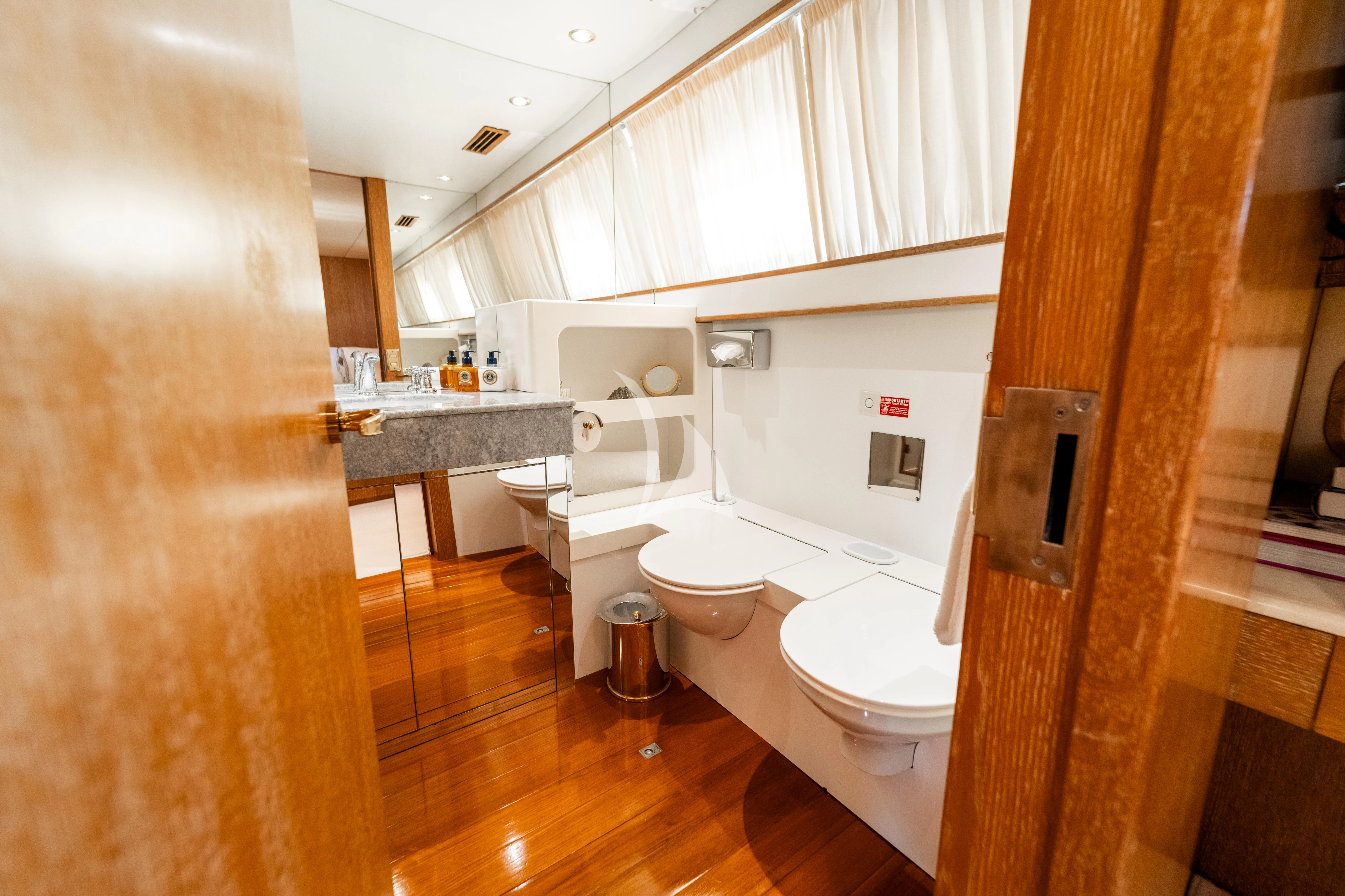 a bathroom with a toilet and sink aboard SEA LADY II Yacht for Sale