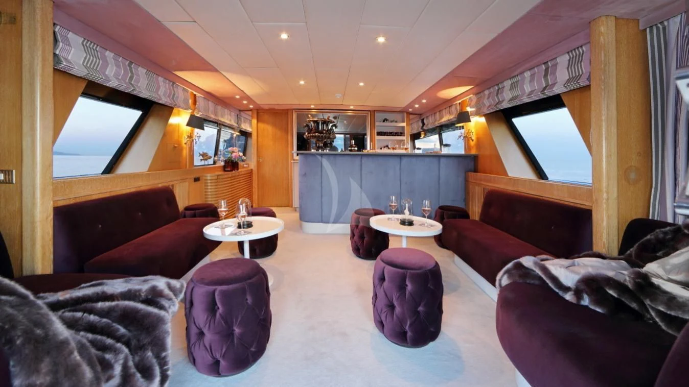 a living room with a large window aboard SEA LADY II Yacht for Sale