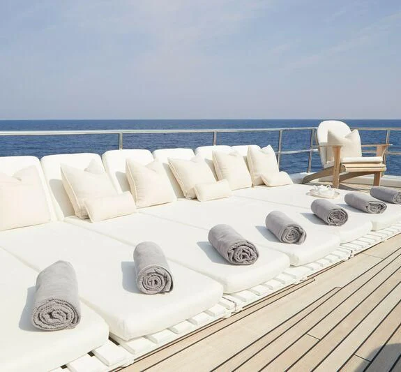 a bed with white pillows and a white bed spread aboard SEA LADY II Yacht for Sale