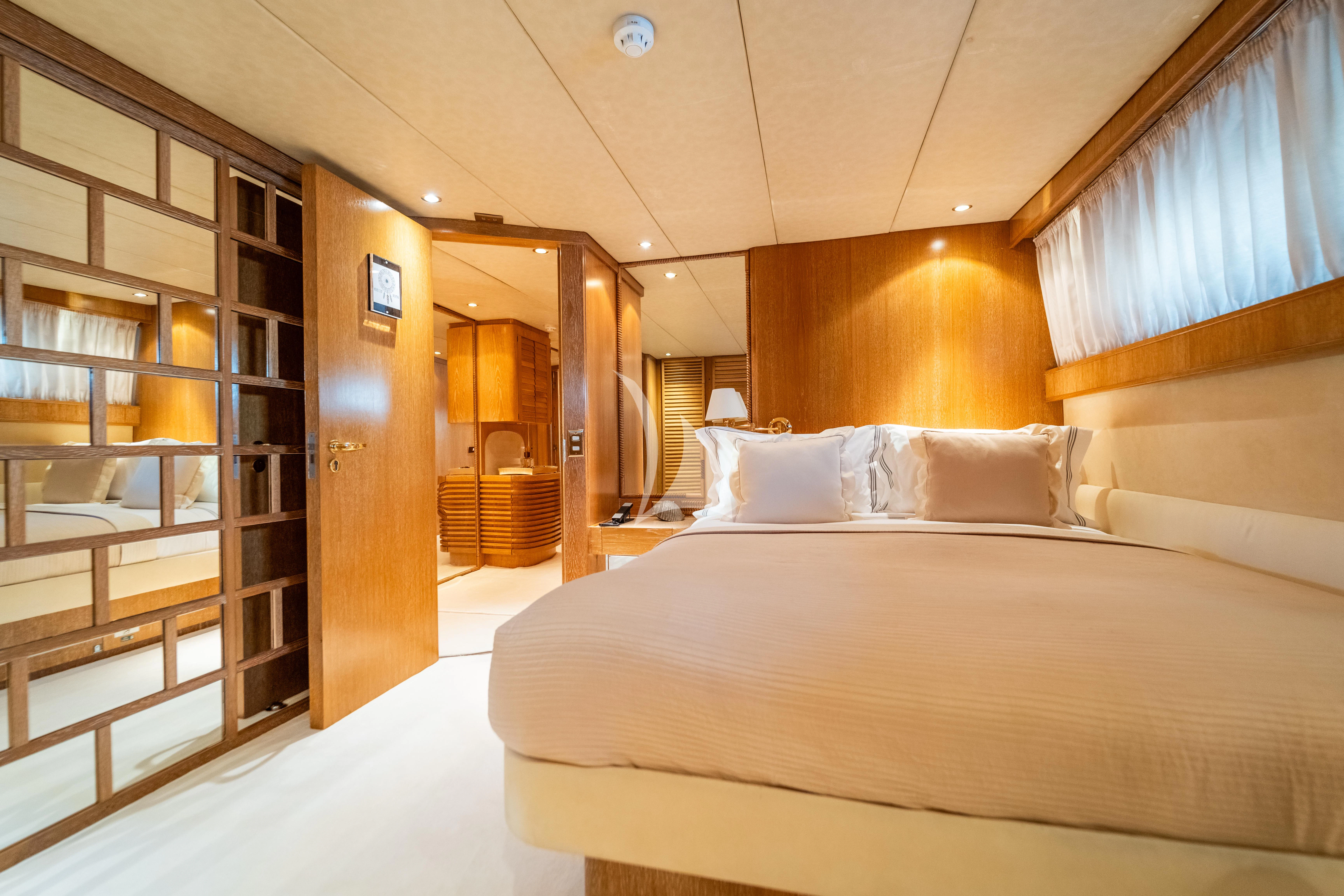 a room with a bed and a bookcase aboard SEA LADY II Yacht for Sale