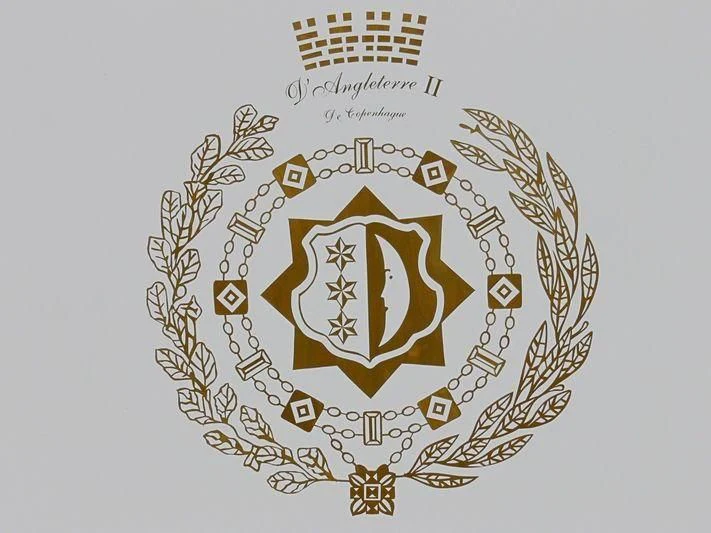 a gold and silver shield with a symbol and text aboard SEA LADY II Yacht for Sale