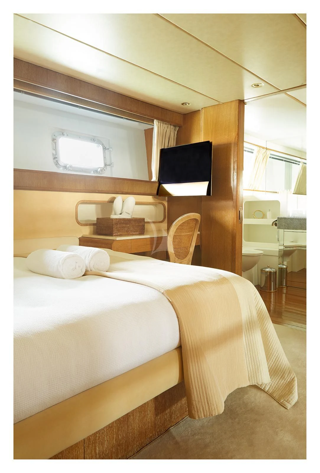 a bed with a television on the wall aboard SEA LADY II Yacht for Sale