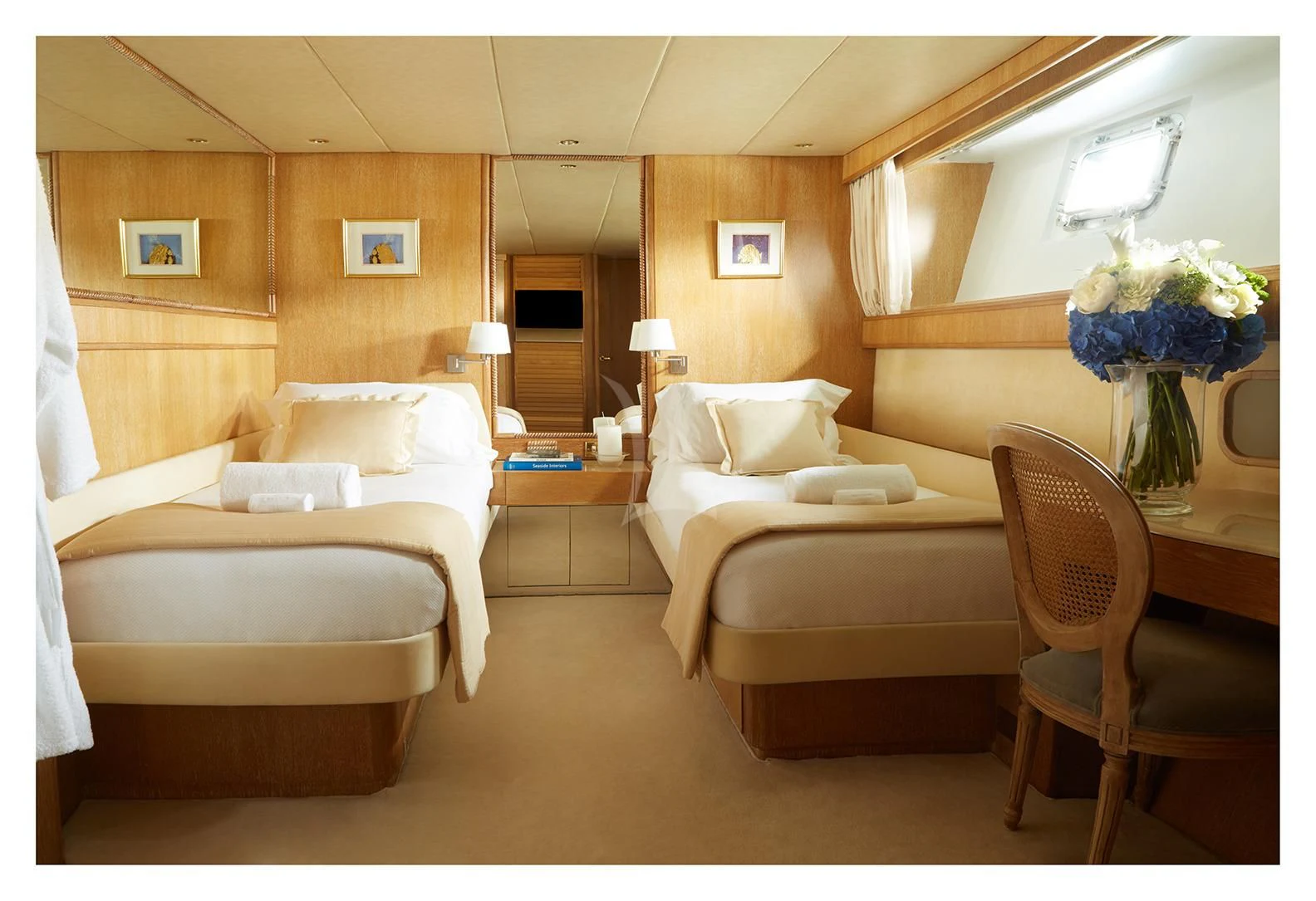 a room with a bed and a chair aboard SEA LADY II Yacht for Sale