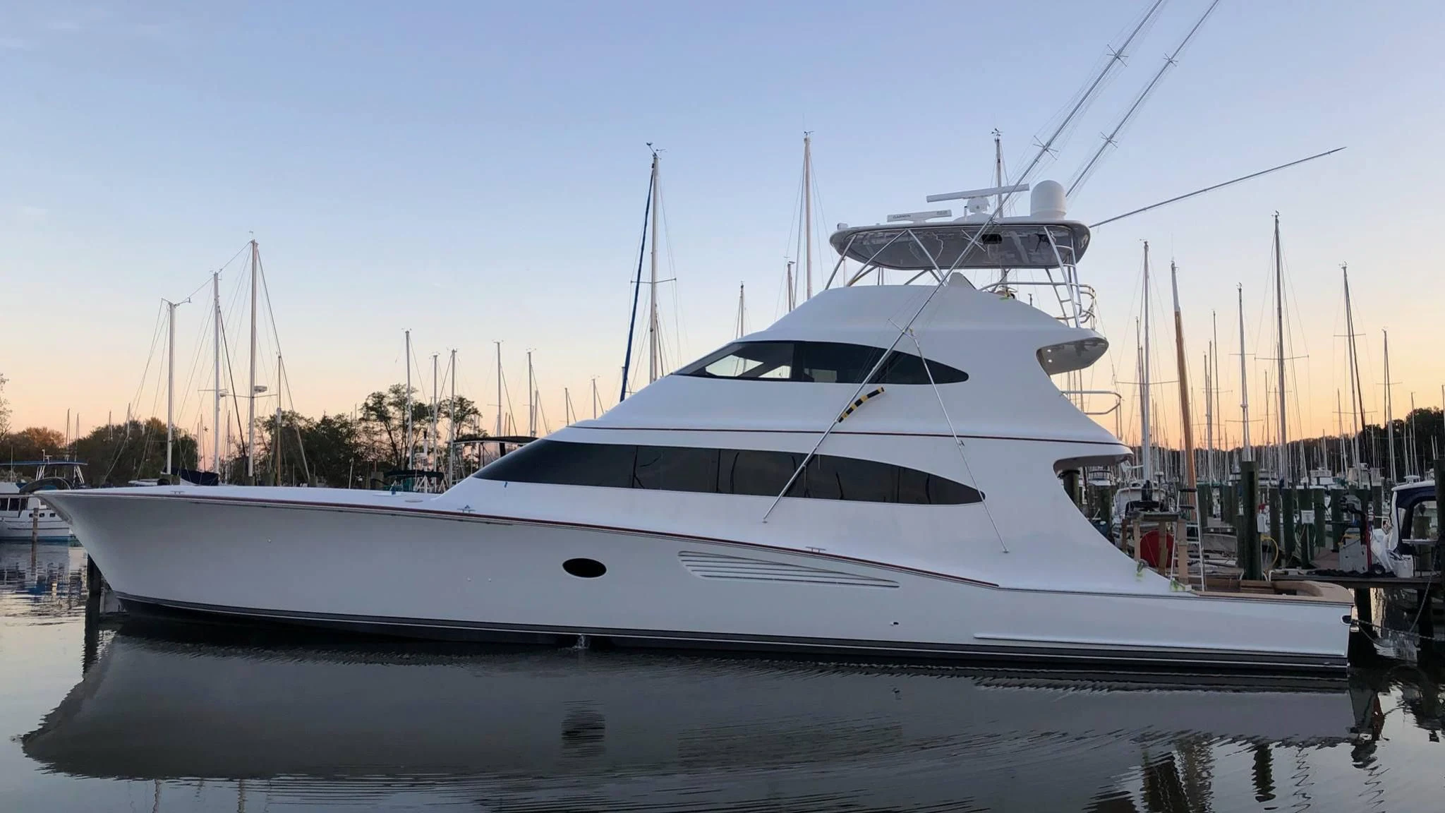 a white yacht in a harbor aboard 18 REELER Yacht for Sale