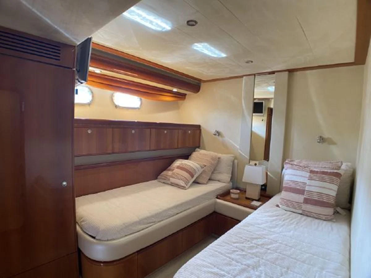 a room with two beds aboard 2005 760 FERRETTI MOTOR YACHT Yacht for Sale