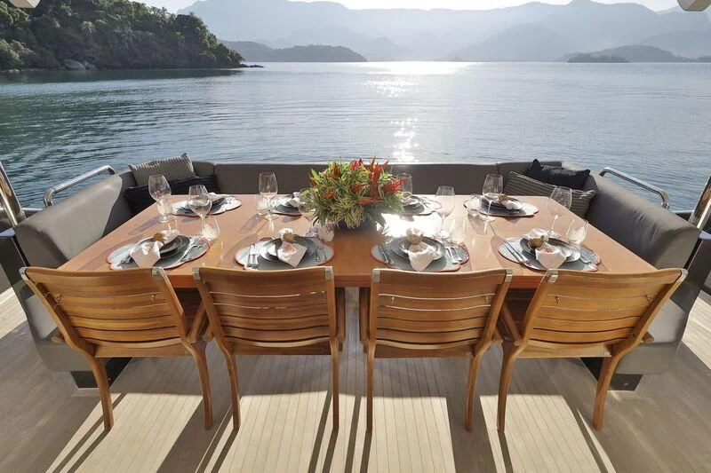 a table set for a dinner party aboard OKTO Yacht for Sale