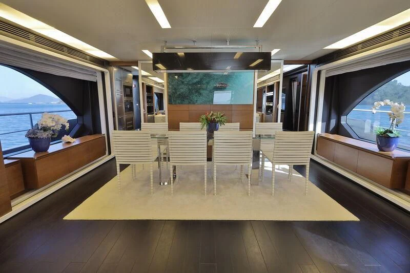 a room with a table and chairs aboard OKTO Yacht for Sale