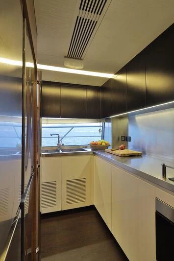 a kitchen with a large metal ladder aboard OKTO Yacht for Sale