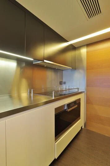a kitchen with a stainless steel oven aboard OKTO Yacht for Sale