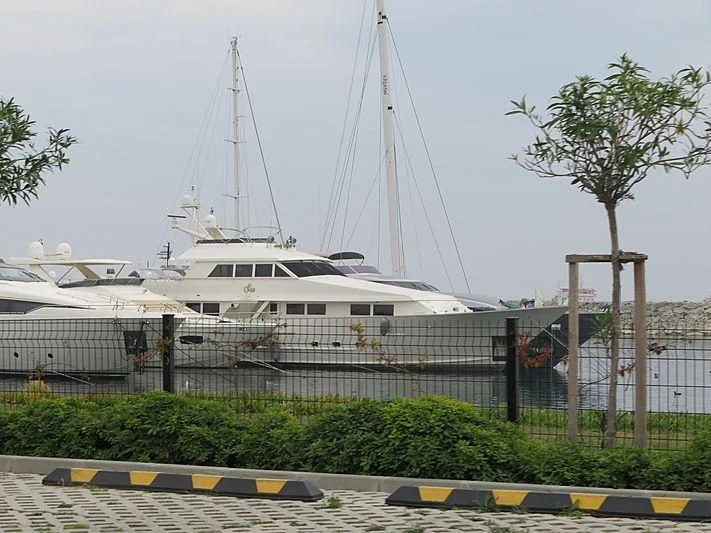 a large white boat in a harbor aboard SU Yacht for Sale