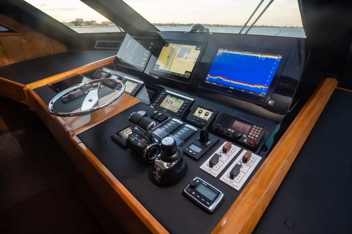 a desk with multiple computers and electronics aboard KALEEN Yacht for Sale