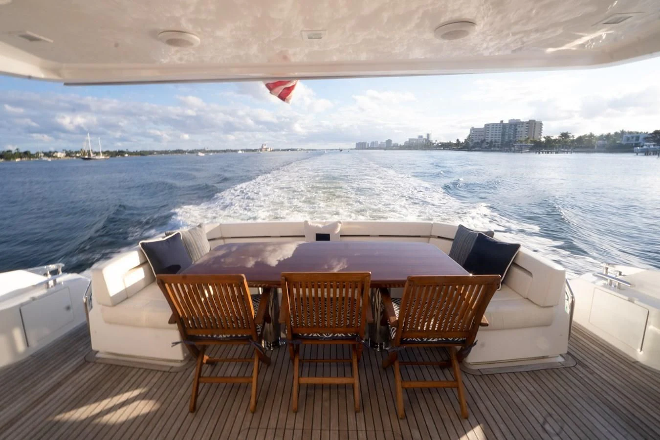 a table and chairs on a deck overlooking a large body of water aboard KALEEN Yacht for Sale