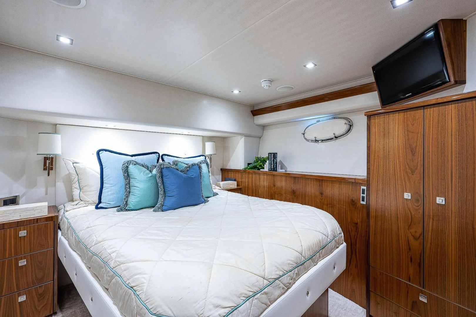 a bedroom with a bed and a television on the wall aboard KALEEN Yacht for Sale