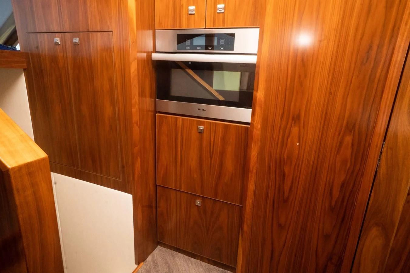 a microwave oven on a wooden cabinet aboard KALEEN Yacht for Sale