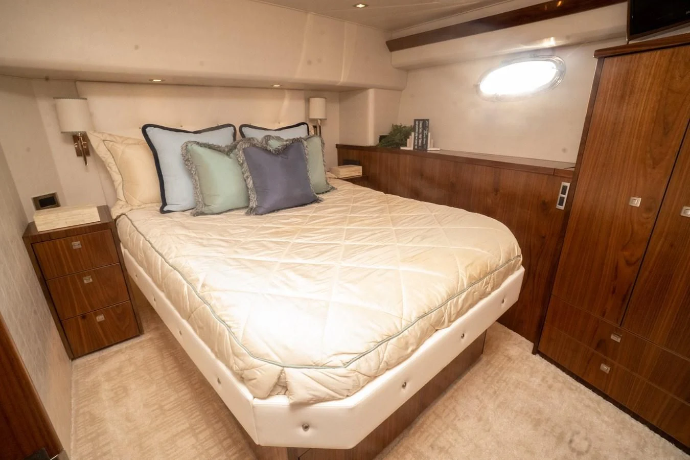 a bed with a white sheet and pillows aboard KALEEN Yacht for Sale