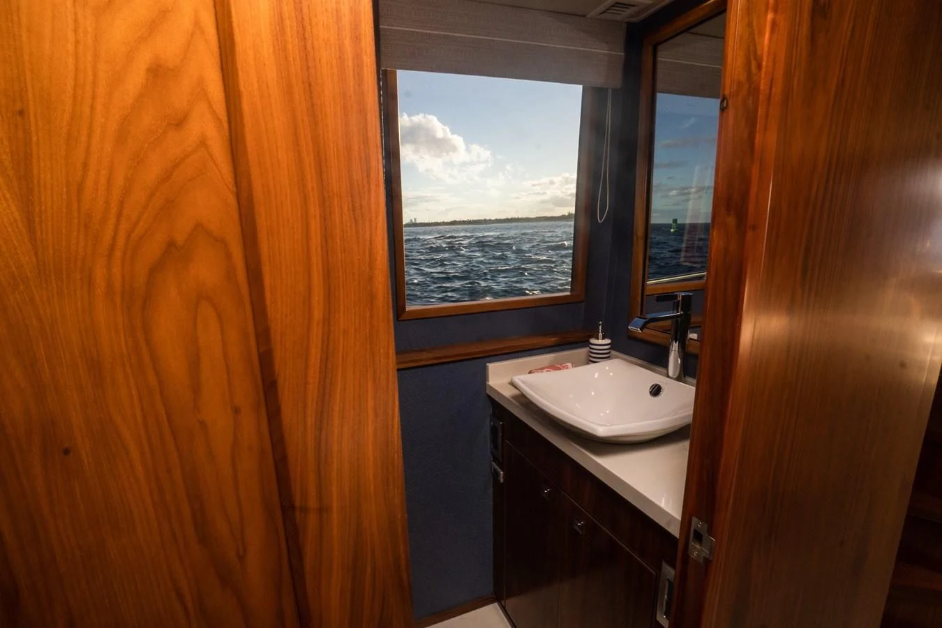 a bathroom with a sink and a window aboard KALEEN Yacht for Sale