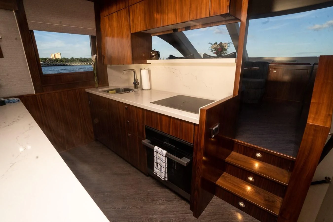 a kitchen with wooden cabinets aboard KALEEN Yacht for Sale