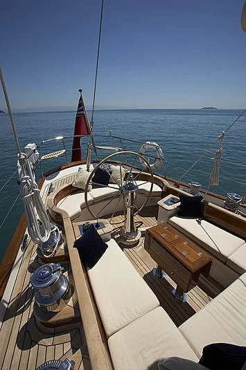 a boat with a flag on the front aboard KEALOHA Yacht for Sale
