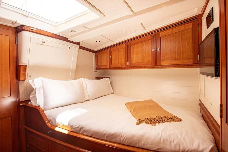 a bed with white sheets aboard KEALOHA Yacht for Sale