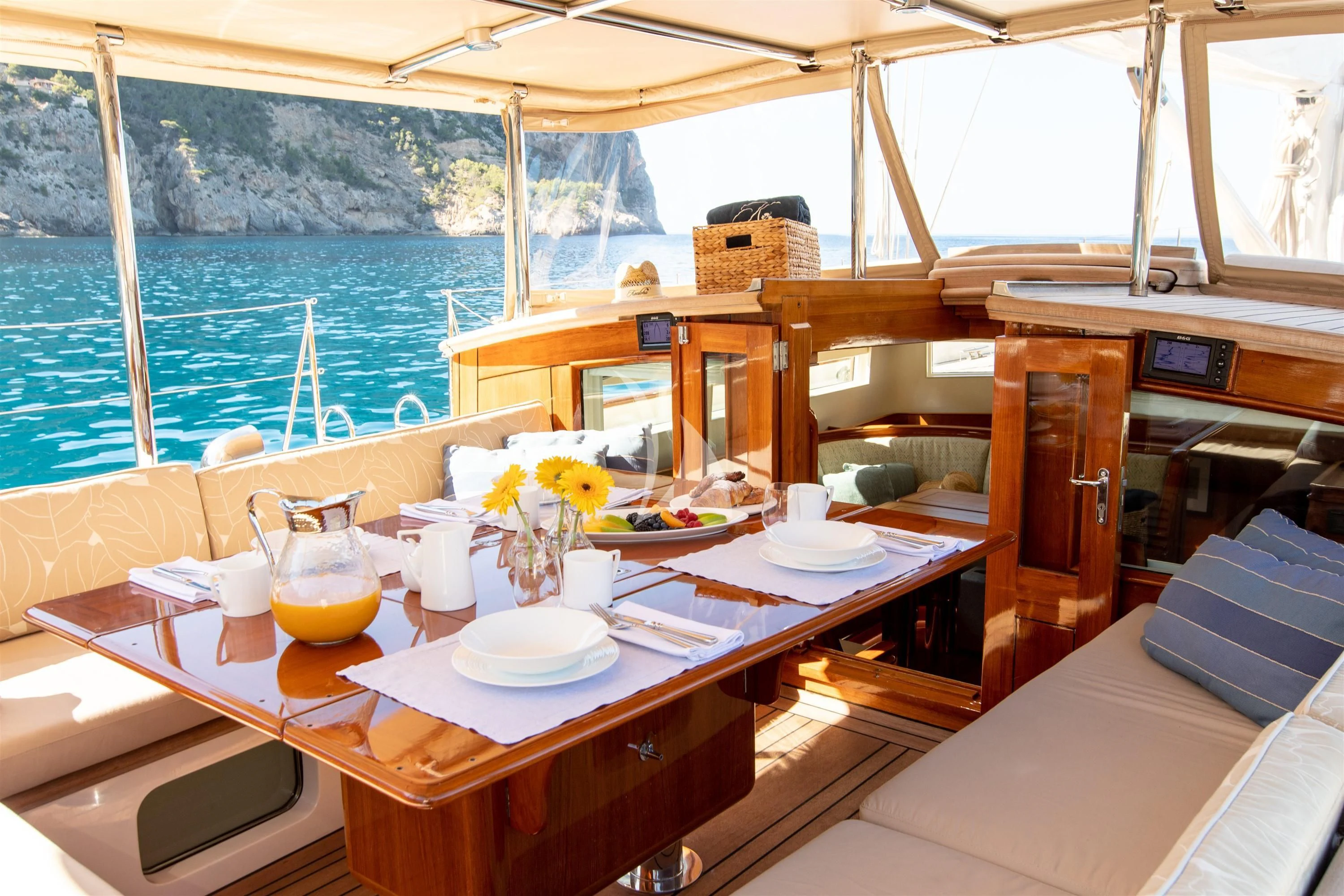 a table with plates and glasses on it aboard KEALOHA Yacht for Sale