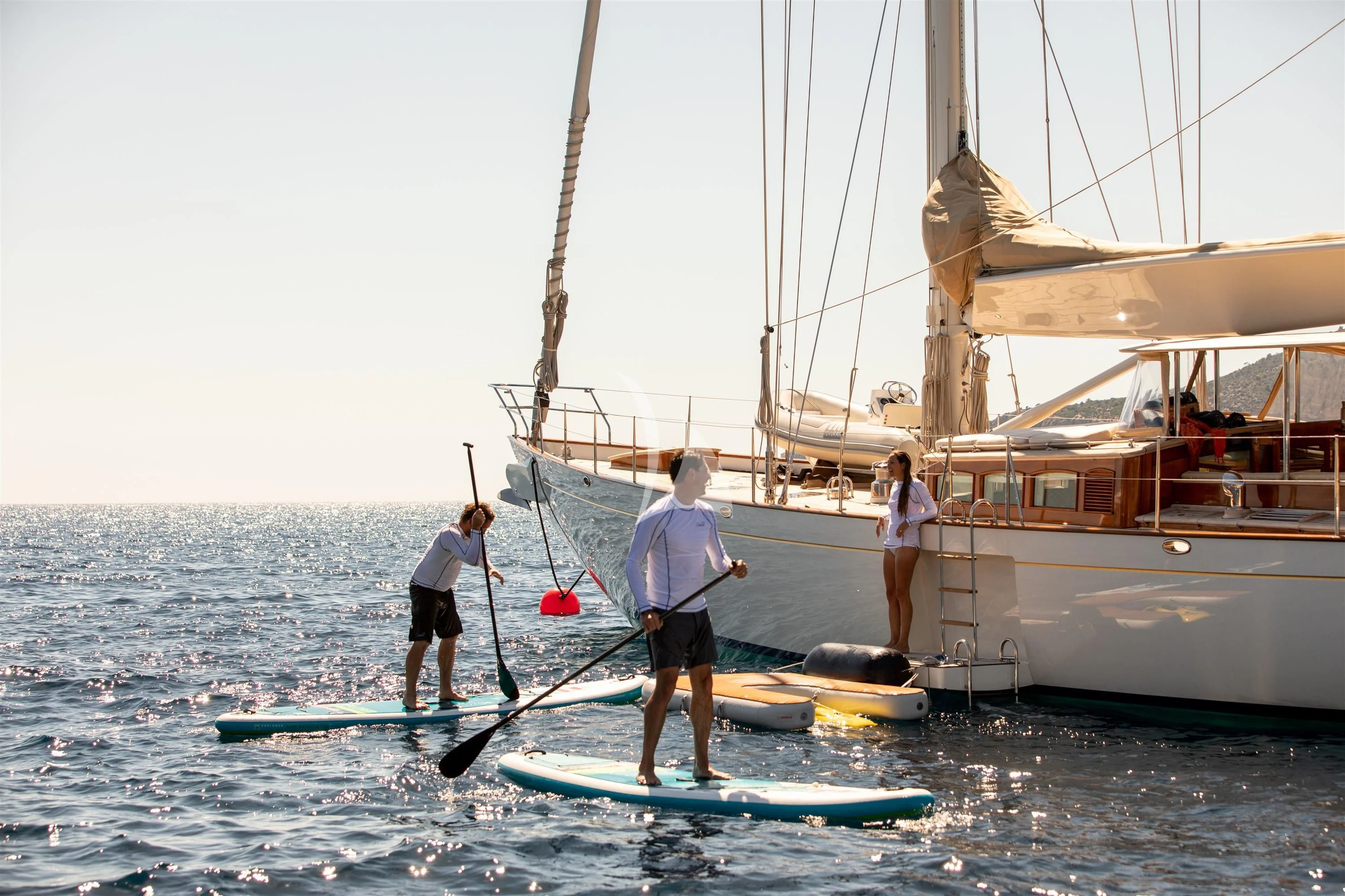 people on surfboards in the water aboard KEALOHA Yacht for Sale