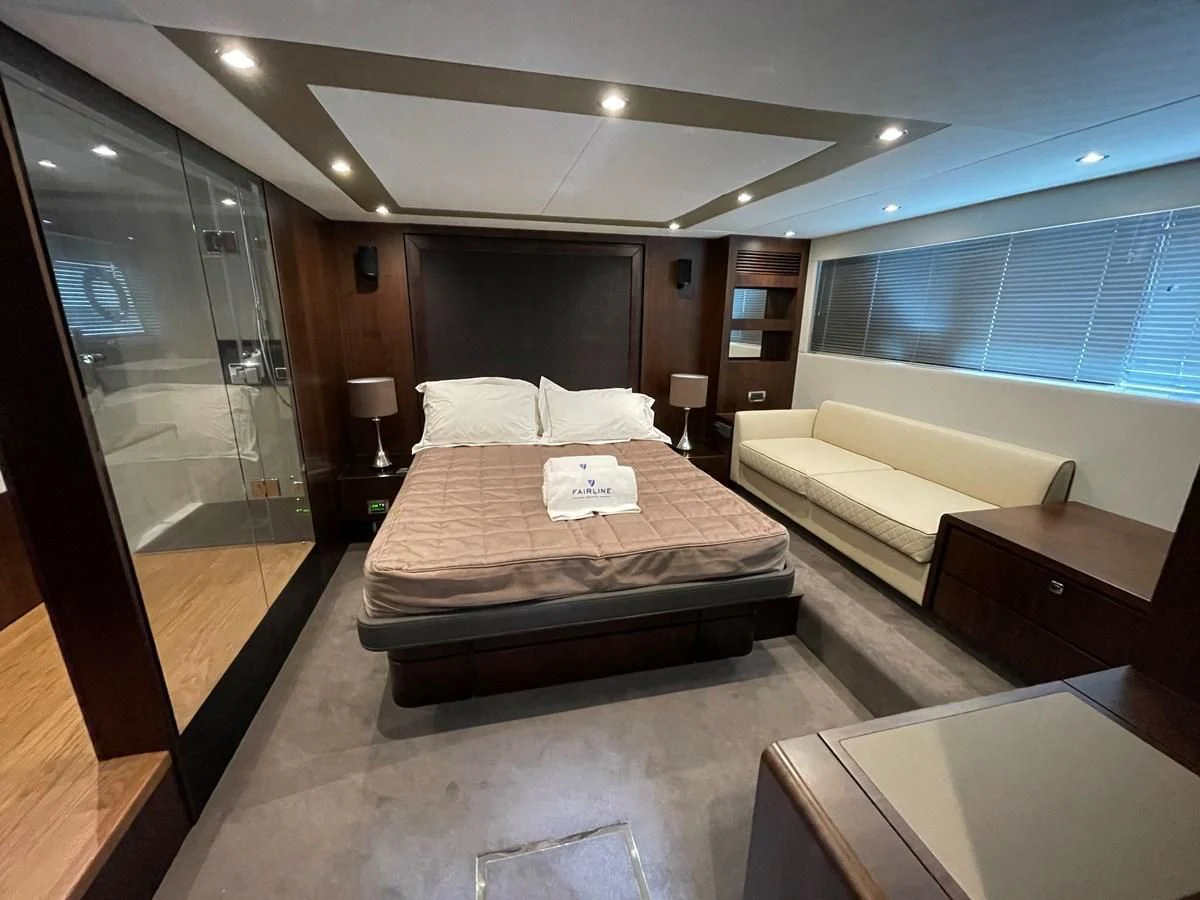 a hotel room with a bed and a large mirror aboard FAIRLINE SQUADRON 65 Yacht for Sale