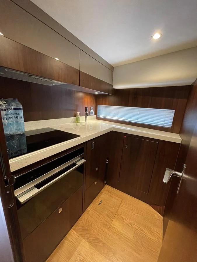 a kitchen with a wooden floor aboard FAIRLINE SQUADRON 65 Yacht for Sale