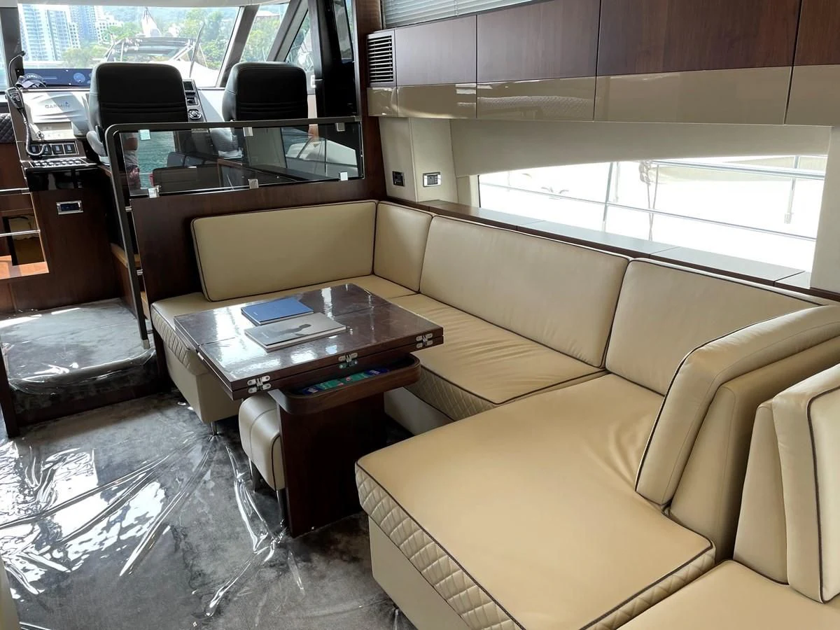 a living room with a couch and coffee table aboard FAIRLINE SQUADRON 65 Yacht for Sale